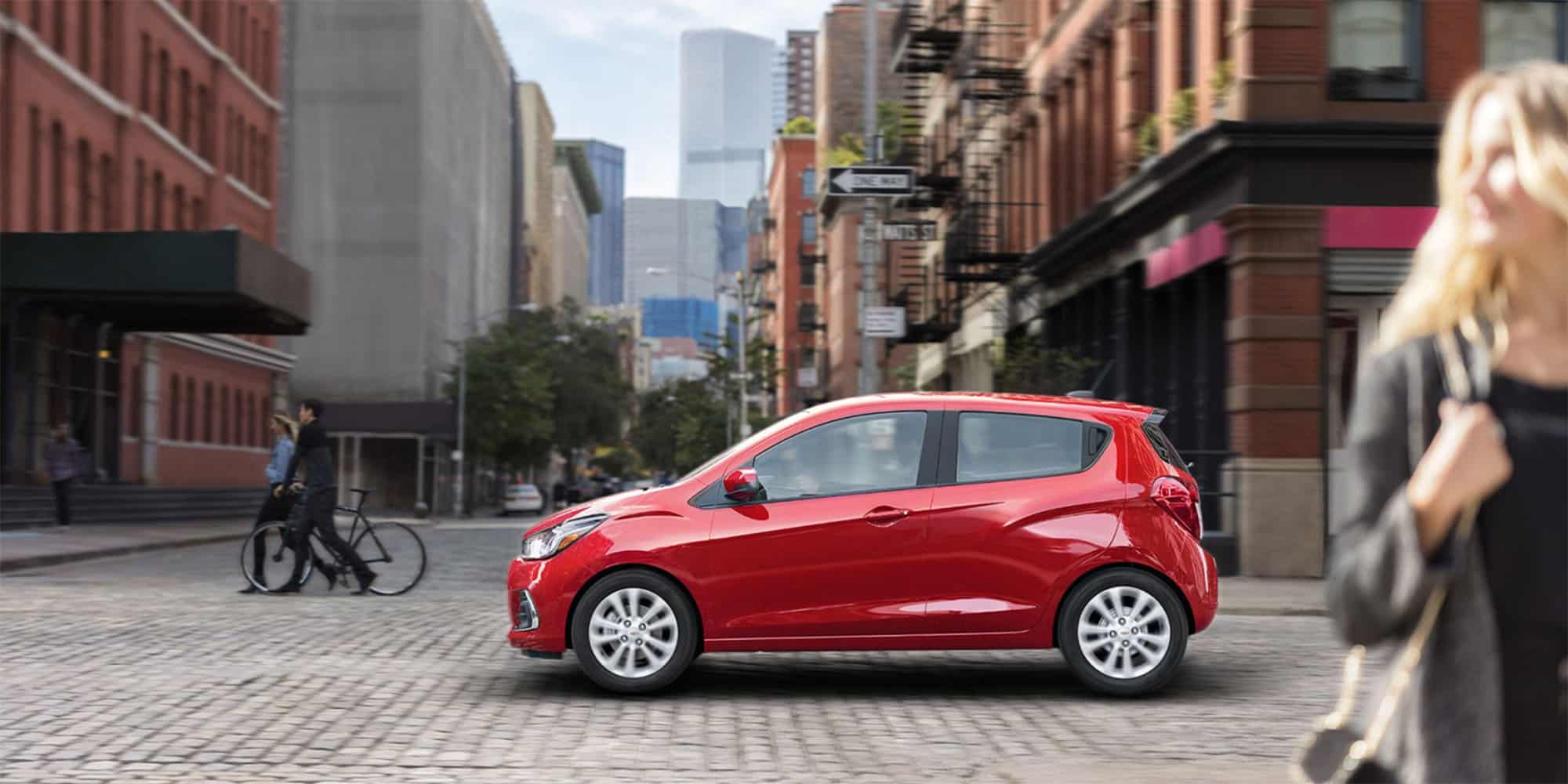 2018 Chevrolet Spark red color on road in city hd wide wallpaper