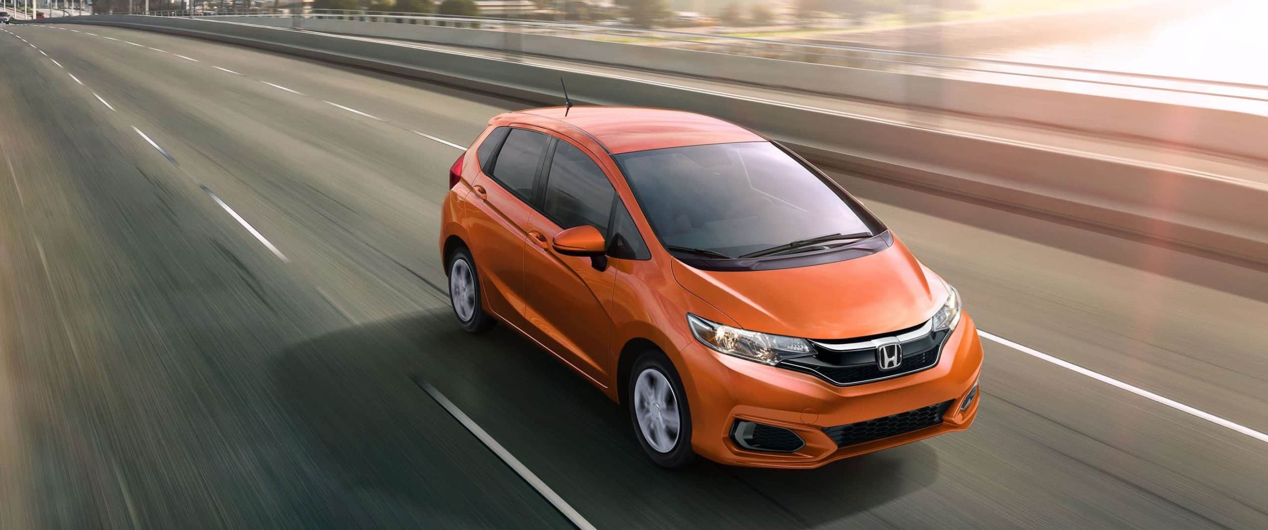 2018 Honda Fit orange color on fury bridge in speed blur background widescreen hd wallpaper